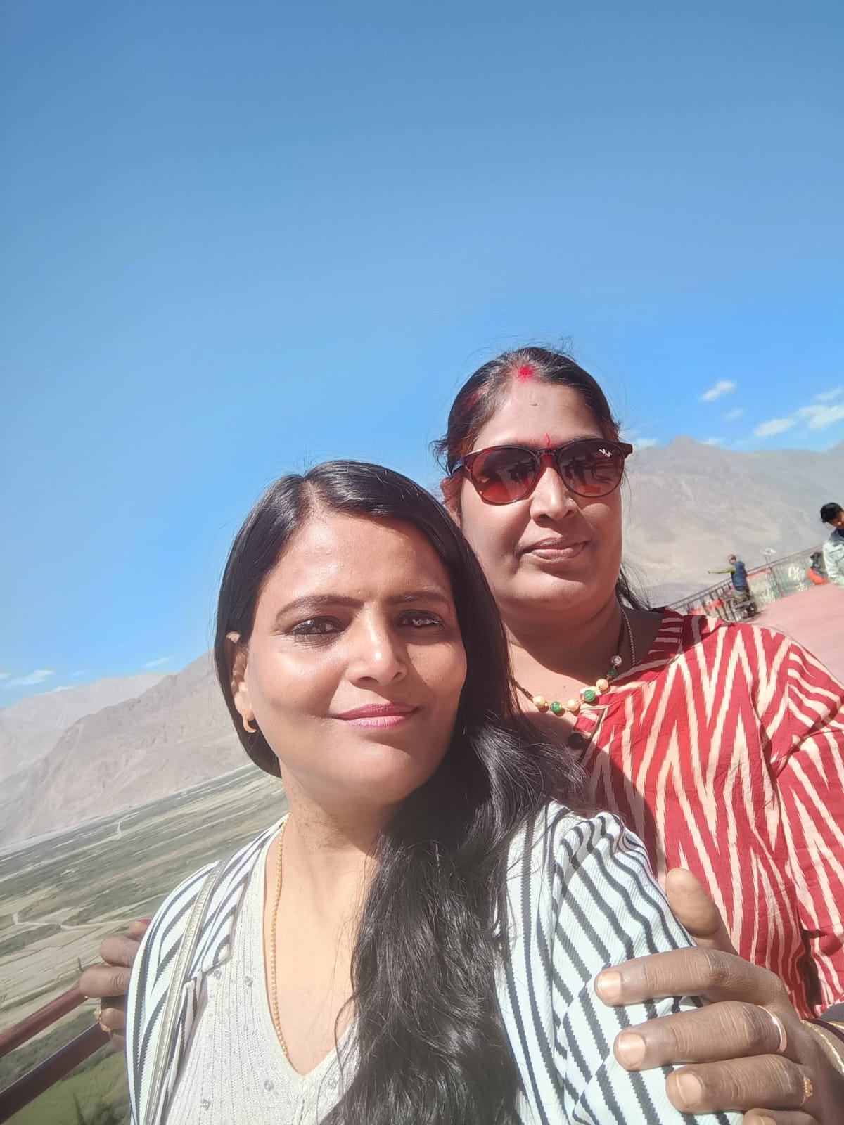 Two Shubh Yatra travellers at a viewpoint above the Nubra Valley